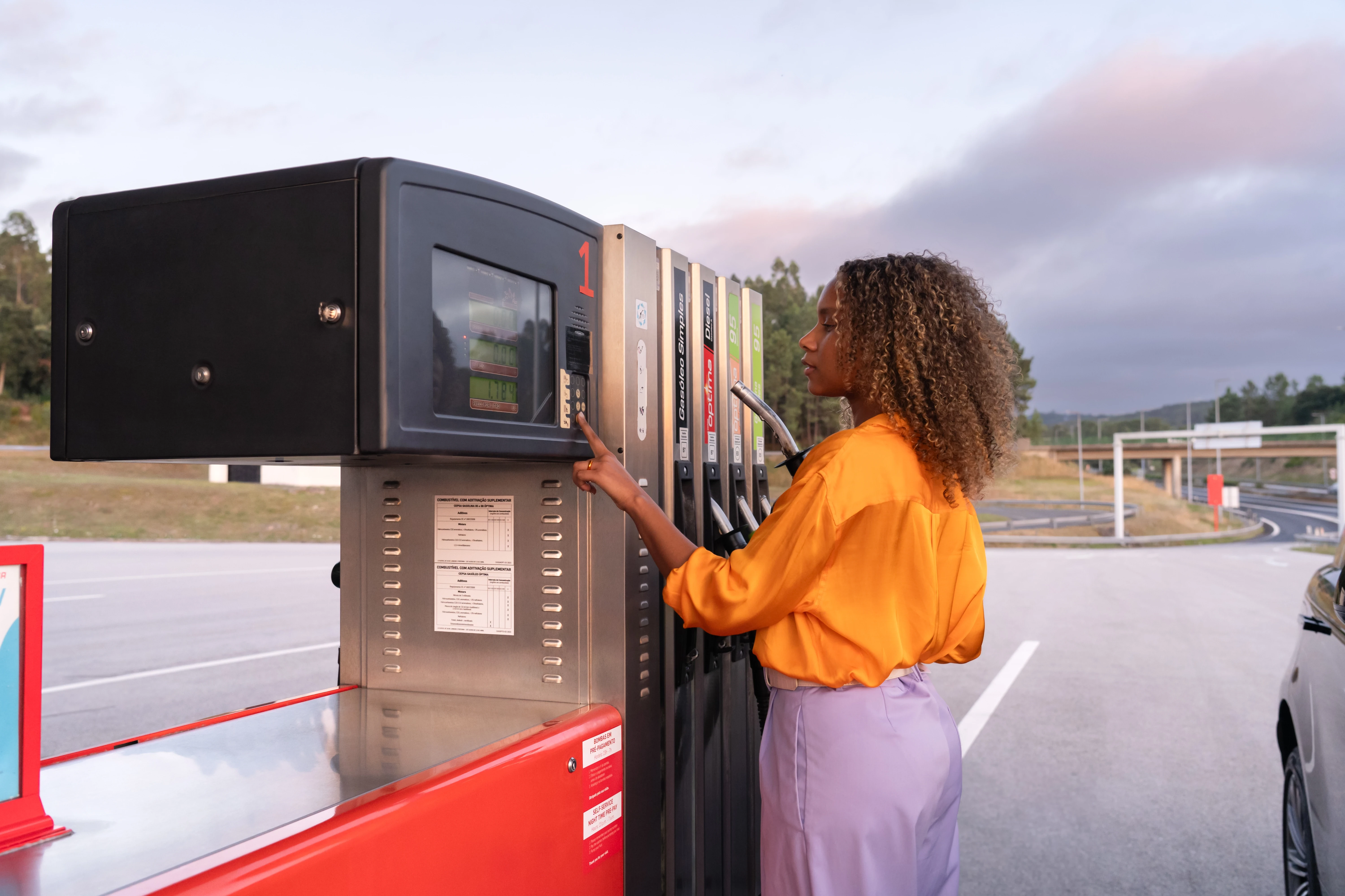 Woman using Petrotec fuel dispenser: product interaction and photography direction