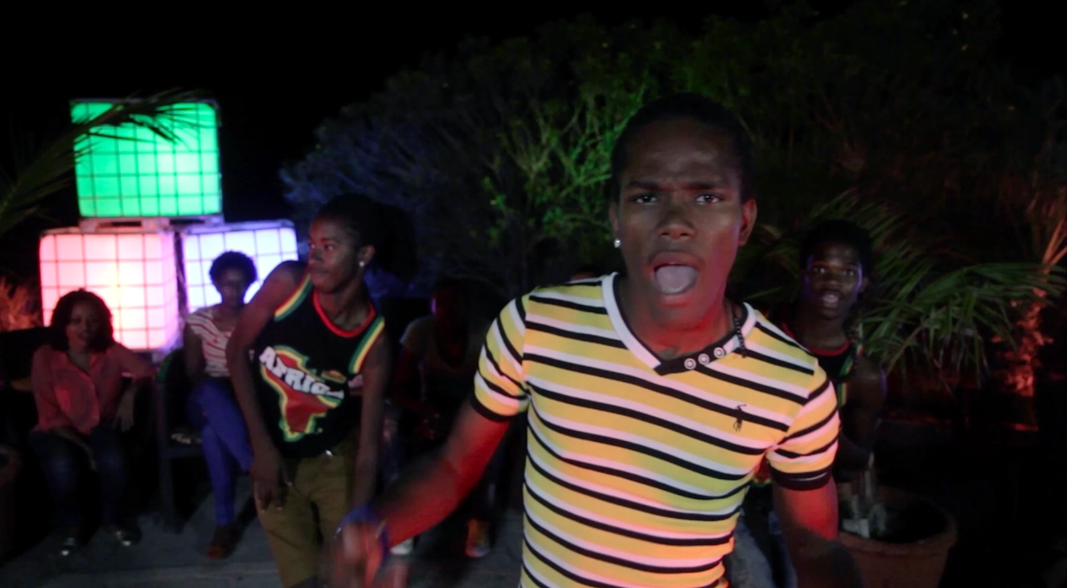 TV spot still: party scene with dancers and coloured lights